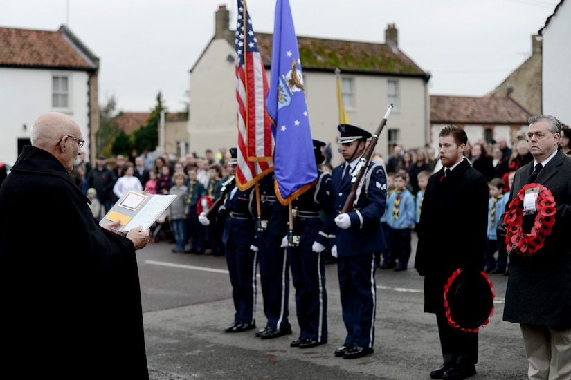 5 Facts About Veterans Day 6 Color guard and officials stand with wreaths.